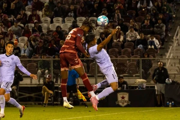 soccer player header aerial duel